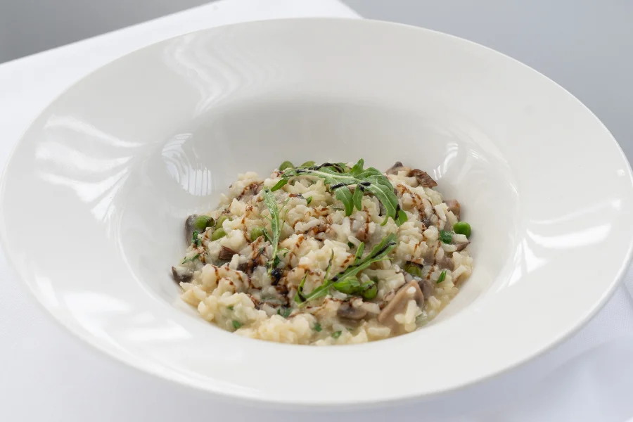 Mushroom Risotto Sauteed peas – Truffle essence – Wild forest mushrooms Mushroom Risotto Sauteed peas – Truffle essence – Wild forest mushrooms