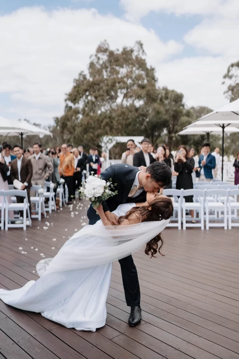 Bride and groom kissing after Bramleigh Estate outdoor wedding ceremony