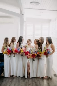 Bridal party with bright florals in vip suite